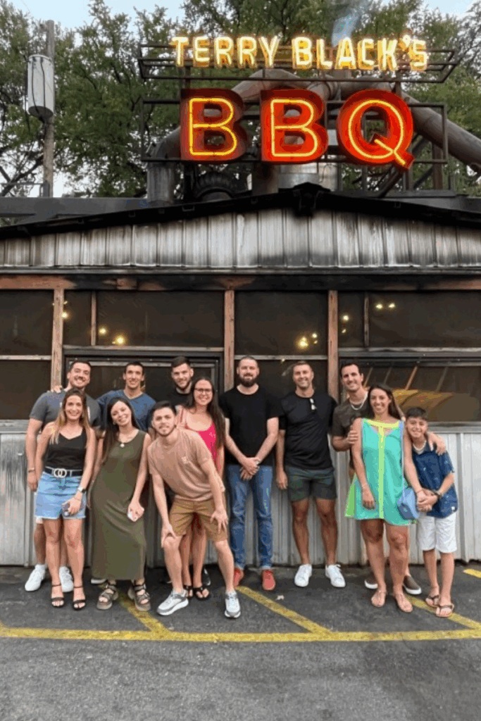 Group posing outside Terry Black's BBQ.